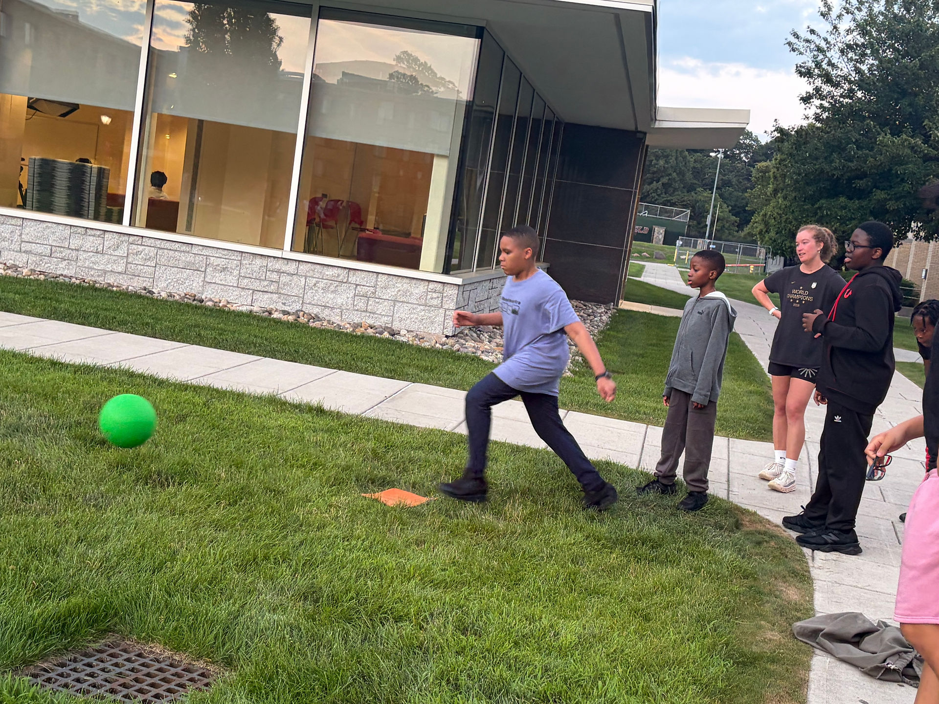 Student kicking kickball