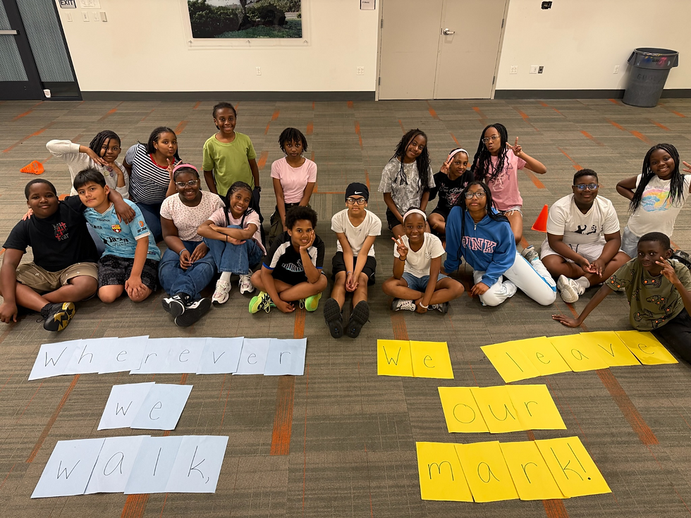 6th grade class posing in front of handmade sign