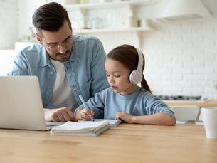 Dad and child homeschooling
