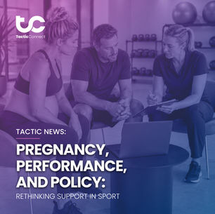 Three people in a gym studio reviewing maternity policy on a clipboard beside a laptop, focused and serious, with weights and exercise balls behind.