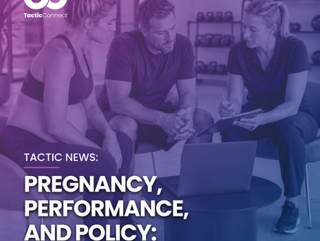 Three people in a gym studio reviewing maternity policy on a clipboard beside a laptop, focused and serious, with weights and exercise balls behind.