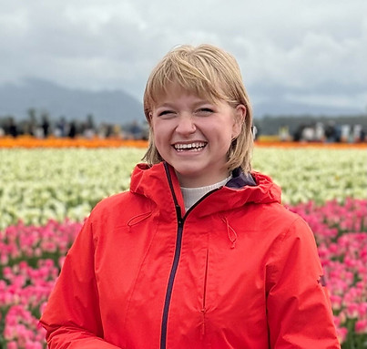 Social Media Manager Anna S. in a field of flowers