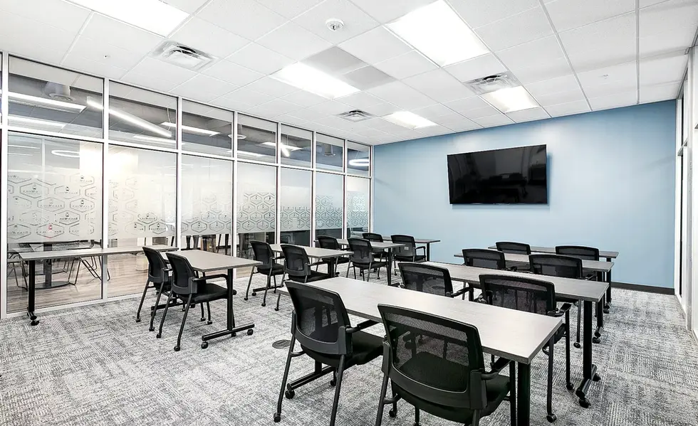 Bright corporate meeting room with large windows and leather chairs
