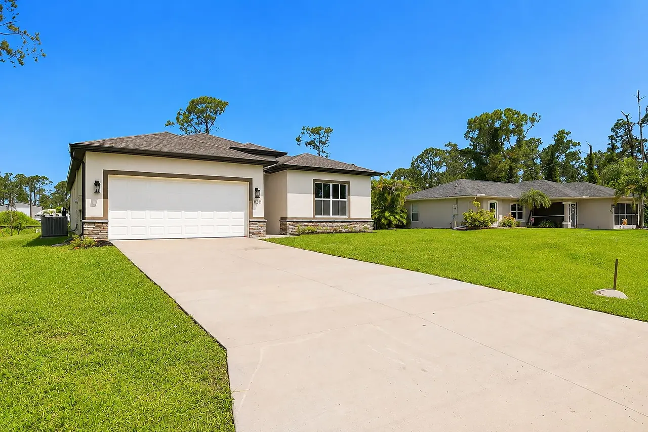 Front exterior of a modern single-story home with a two-car garage in Sarasota, Florida