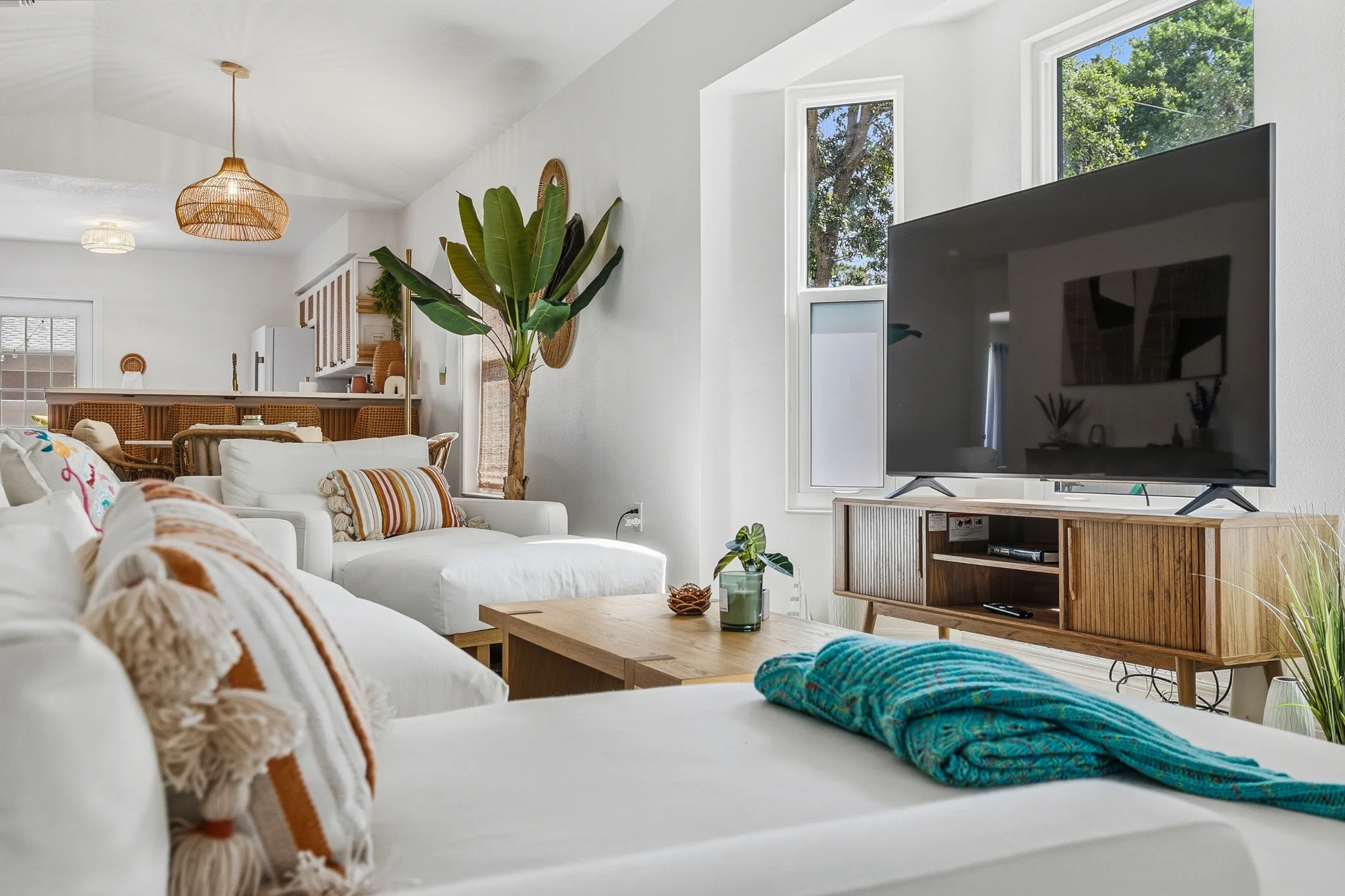 Cozy staged living room with sofa, TV, and natural light in a Manatee County listing