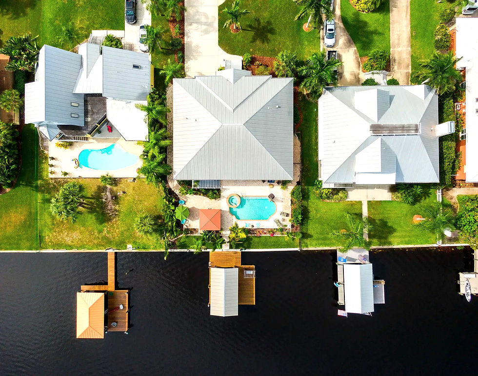 Aerial drone photo of waterfront homes with pools and docks in Sarasota, Florida