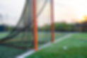 Late afternoon photo of a lacrosse goal on a synthetic turf field before a night game._.jp
