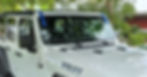 White vehicle windshield with blue installation tape