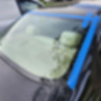 Rear vehicle glass secured with blue installation tape