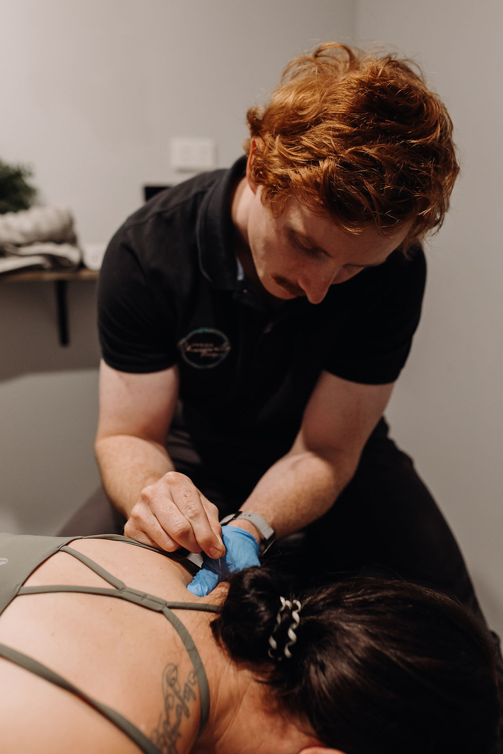 Sarina chiropractor performing soft tissue therapy on a patient