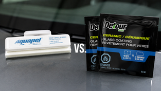 Aquapel applicator and Detour ceramic glass treatment wipes sitting on vehicle hood.