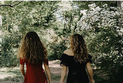 A woman and daughter walking in park