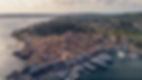 The Port of Saint-Tropez seen from the sky, with its luxury yachts and restaurants, and th