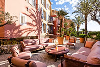 outdoor sofas in pink and orange on the terrace of the Byblos in Saint-Tropez