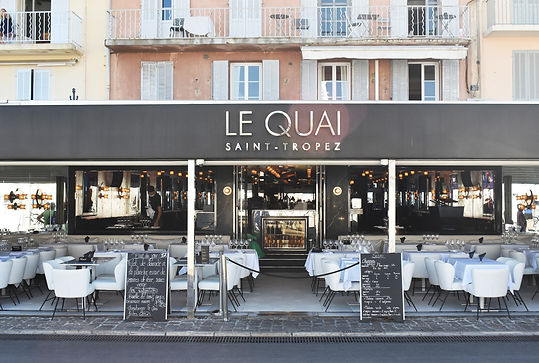 A taxi driver dropping off American tourists in front of the Le Quai club and restaurant i