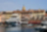 a taxi driver in front of the Saint-Tropez harbor master’s office with yachts