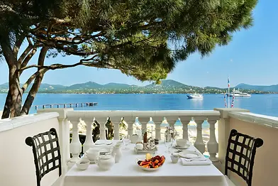 a breakfast with fruits and a coffee on a white tablecloth overlooking the golf of Saint-Tropez at the White Horse Palace in Saint-Tropez