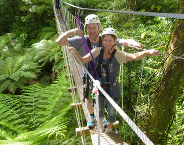 A man and a woman doing a zipline canopy tour