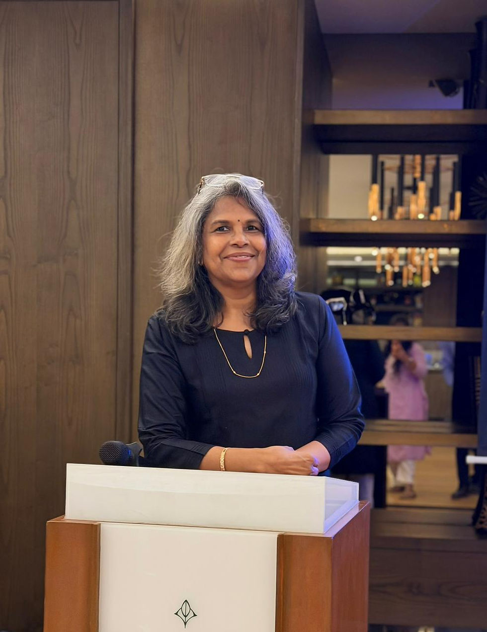 A portrait of a smiling woman.