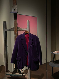 Purple jacket hanging on an old wooden construction.