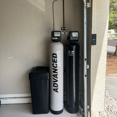 Advanced water softener system installed in a garage