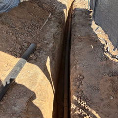 Deep narrow trench for underground pipe installation