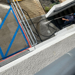 Detailed power washing and heavy grime removal on outdoor concrete stairs in Cerritos, CA.