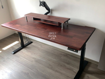 Adjustable height standing desk with solid wood mahogany tabletop and inverted T black legs