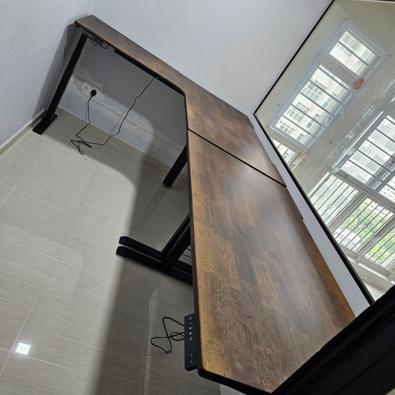 adjustable height Lshape desk in walnut colour tabletops