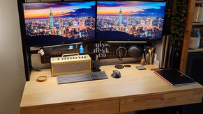 Picture features a premium My-Desk.Co custom solid wood standing desk setup with integrated drawers, upper shelving, and a triple-monitor layout optimized for productivity.