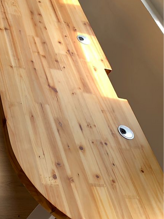 Silver grommet and rear cutout on natural solid wood tabletop in natural colour