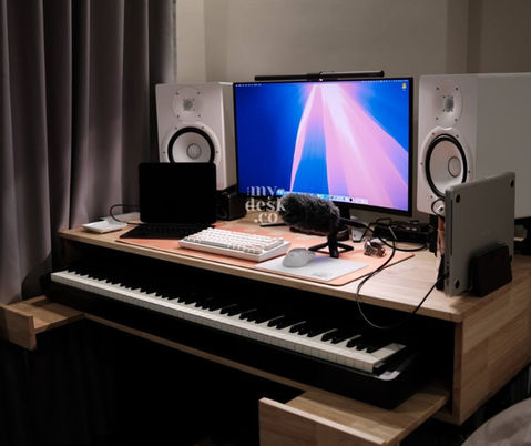 a keyboard sits on a desk next to a computer monitor