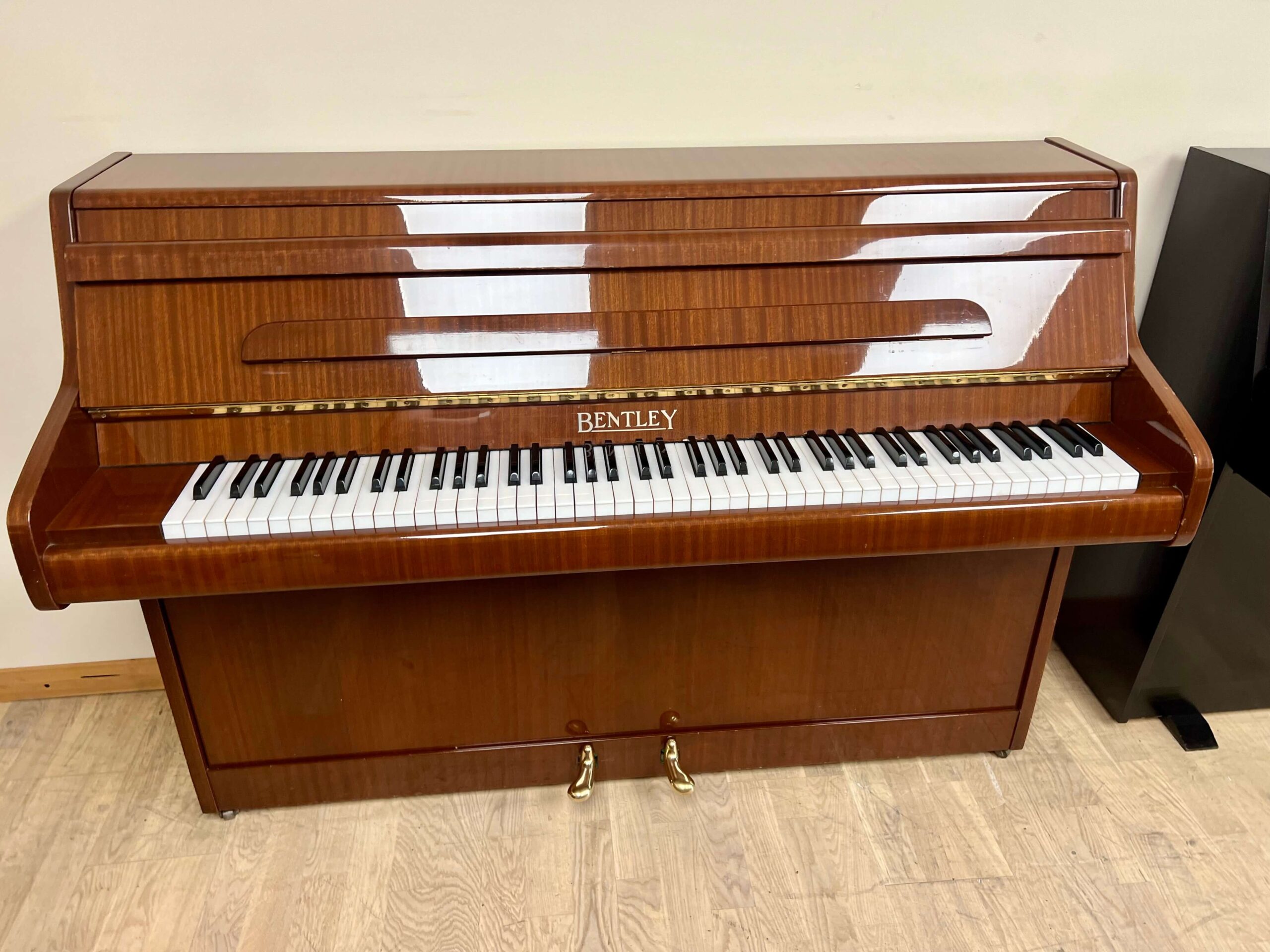 Bentley 85C Upright Piano in dark striped polished mahogany with brass fittings