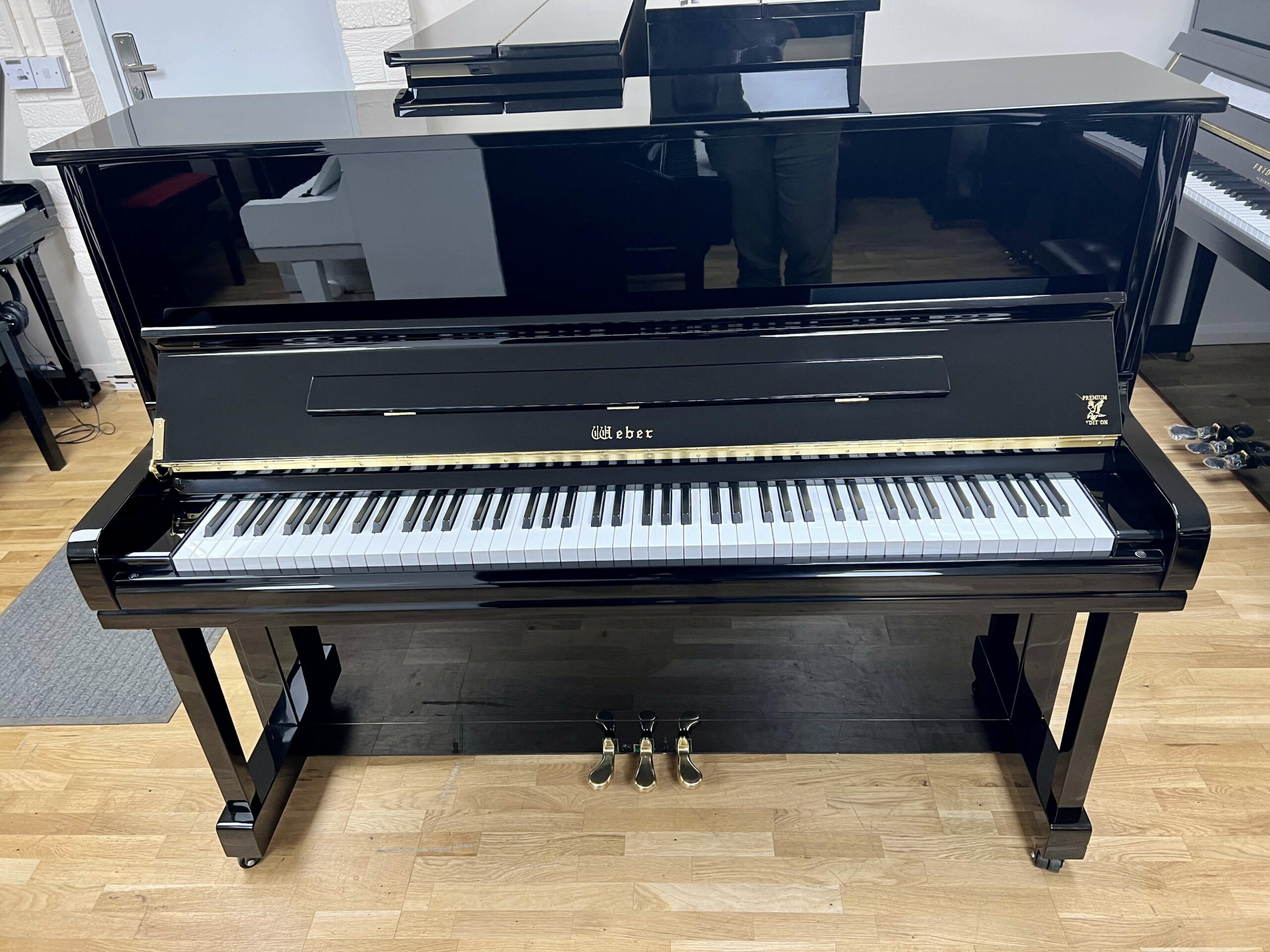 Weber W121 Upright Piano in polished black with brass fittings