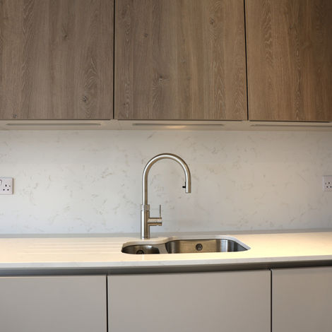 Kitchen worktop and sink with quartz surface and brushed steel tap in a bespoke Reading kitchen