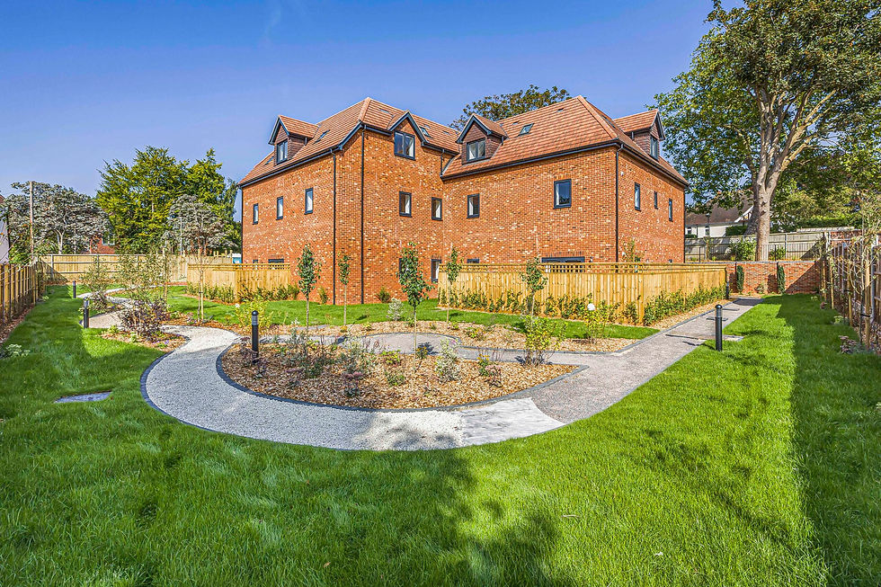 Landscaped garden with curved pathways around a new-build residential development in Reading