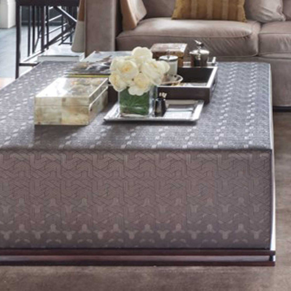 The Langham Ottoman is a sophisticated centerpiece featuring a low-profile silhouette upholstered in a high- quality, geometr