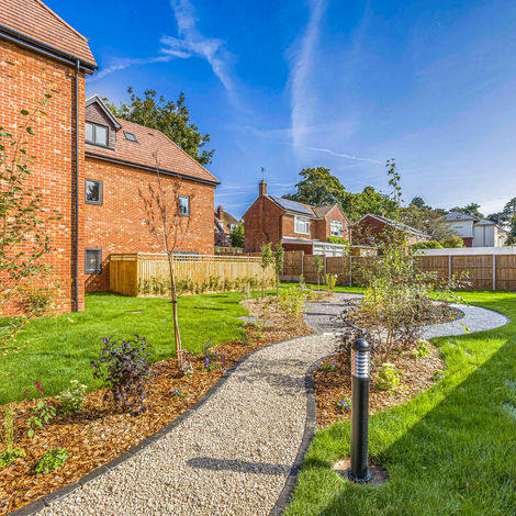 Landscaped garden with winding pathways around a new-build residential development in Reading