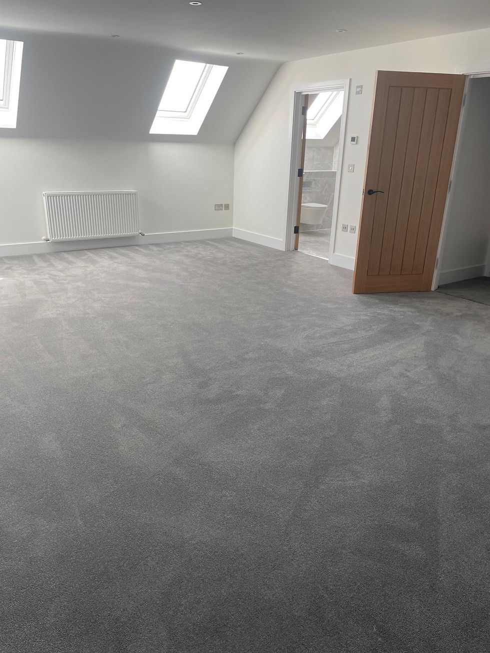 Merit Flooring Hartley Wintney New carpet installation in a bedroom by Merit Flooring Hartley Wintney