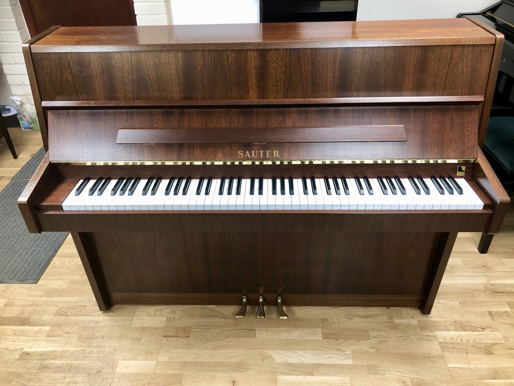 Sauter piano in patterned mahogany with brass fittings