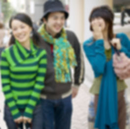 three happy Asian teenagers laughing