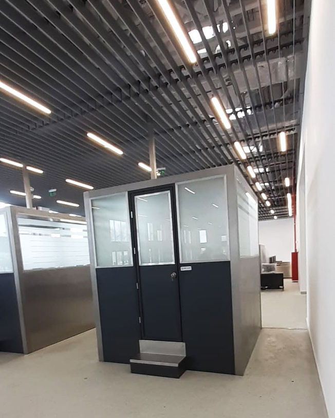 durable passport control booths operated by staff at an airport immigration area