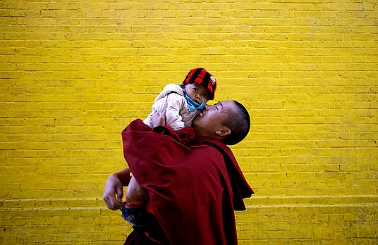 Monk playing with child