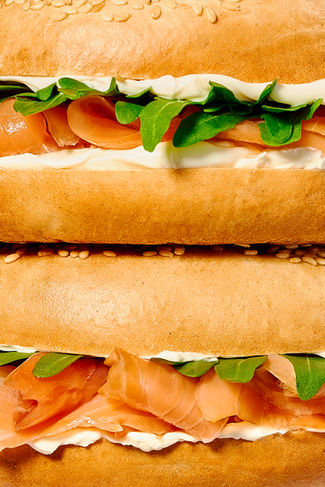 Macro commercial food shot of two stacked salmon cream cheese bagels, food photographer Harrogate