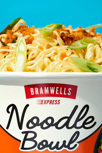 Commercial food  macro photo of bramwells  ready meal noodle bowl, set on a bold blue background, North Yorkshire 