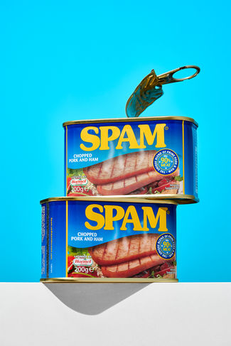 Creative food photo of two cans of Spam stacked on bold blue background, Harrogate