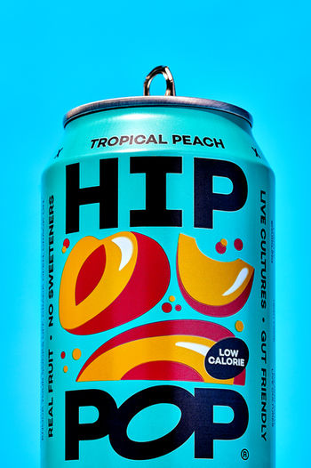 close up product photo of blue hip pop can set on a bold blue backdrop, drink product photography, North Yorkshire 