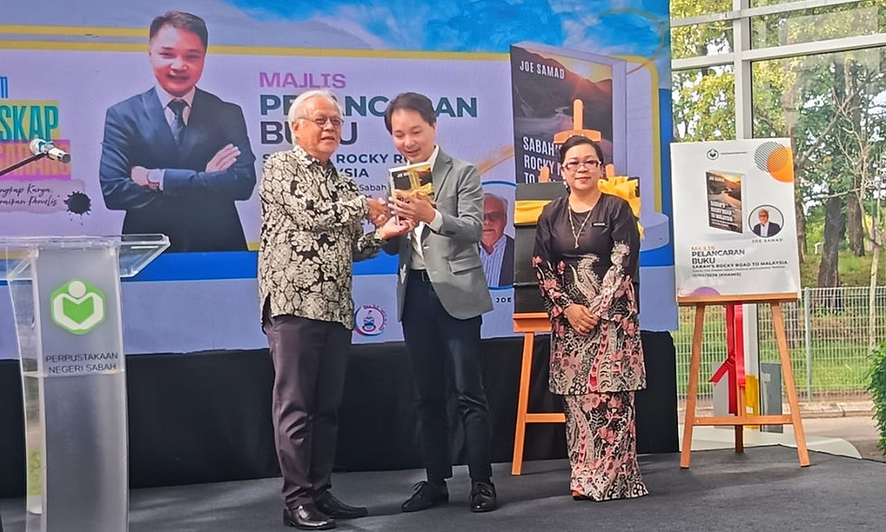 The author presenting the book to the guest of honour