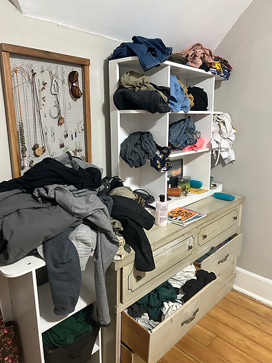 A used dresser is piled with clothes, a shelf, and a homemade chicken wire jewelry rack