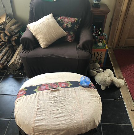 Homemade orange, brown and flowered ottoman and chair covers with matching pillows to prolong the life of old furniture